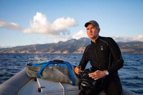 [image] Brian Kerry, Underwater Photographer pictured on a boat with an underwater camera.